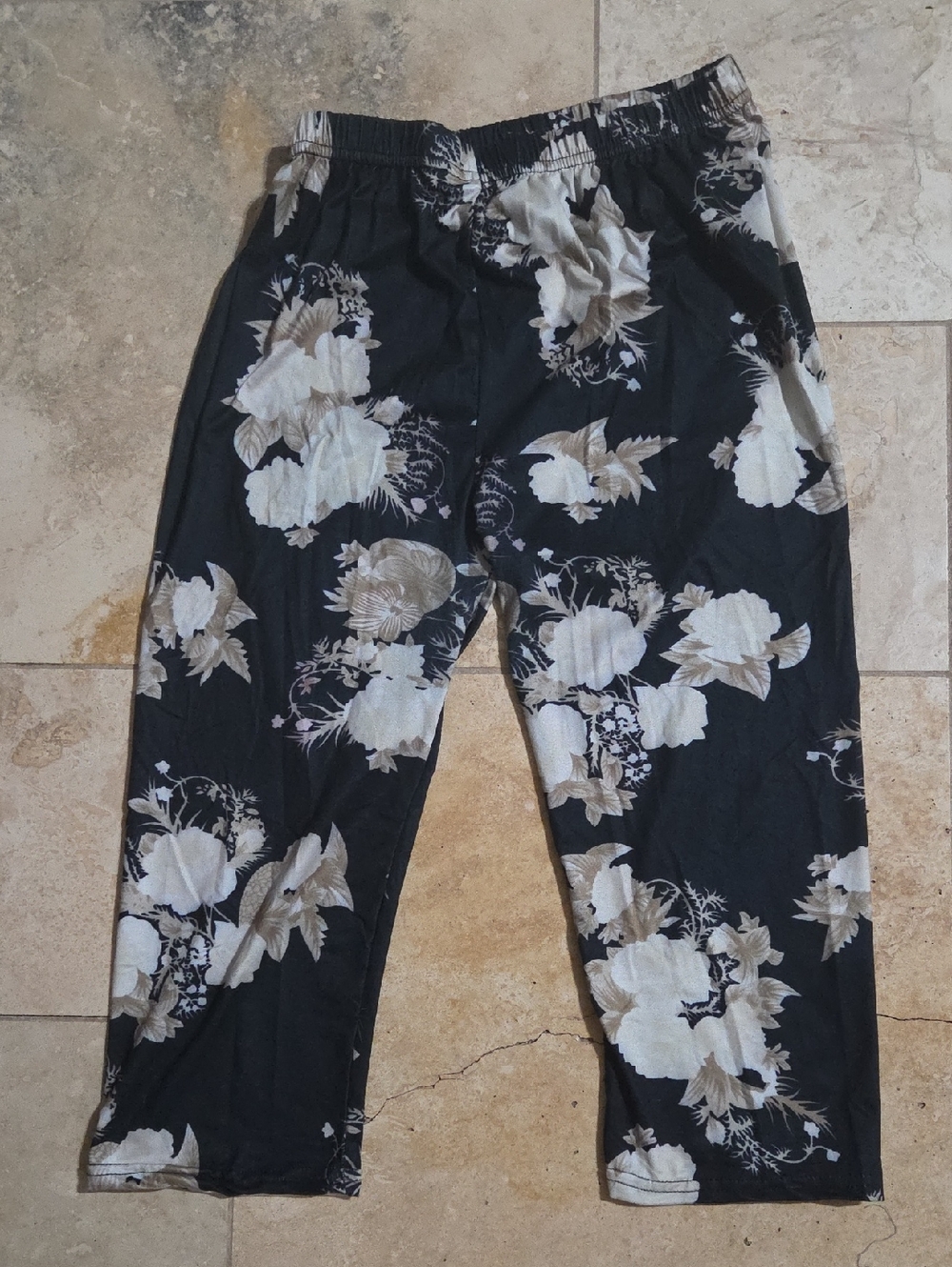 Junior’s size large black capri leggings featuring a cream-colored floral design